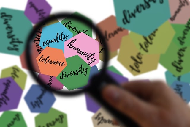 Magnifiying glass examining the words equality, diversion and inclusion