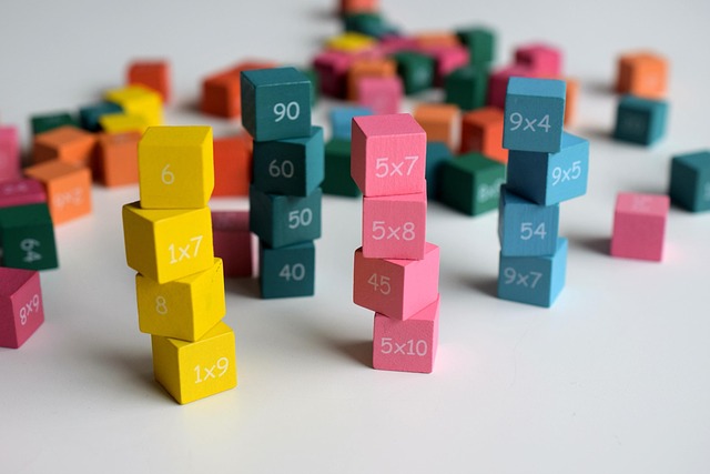 Stacking coloured blocks featuring maths problems