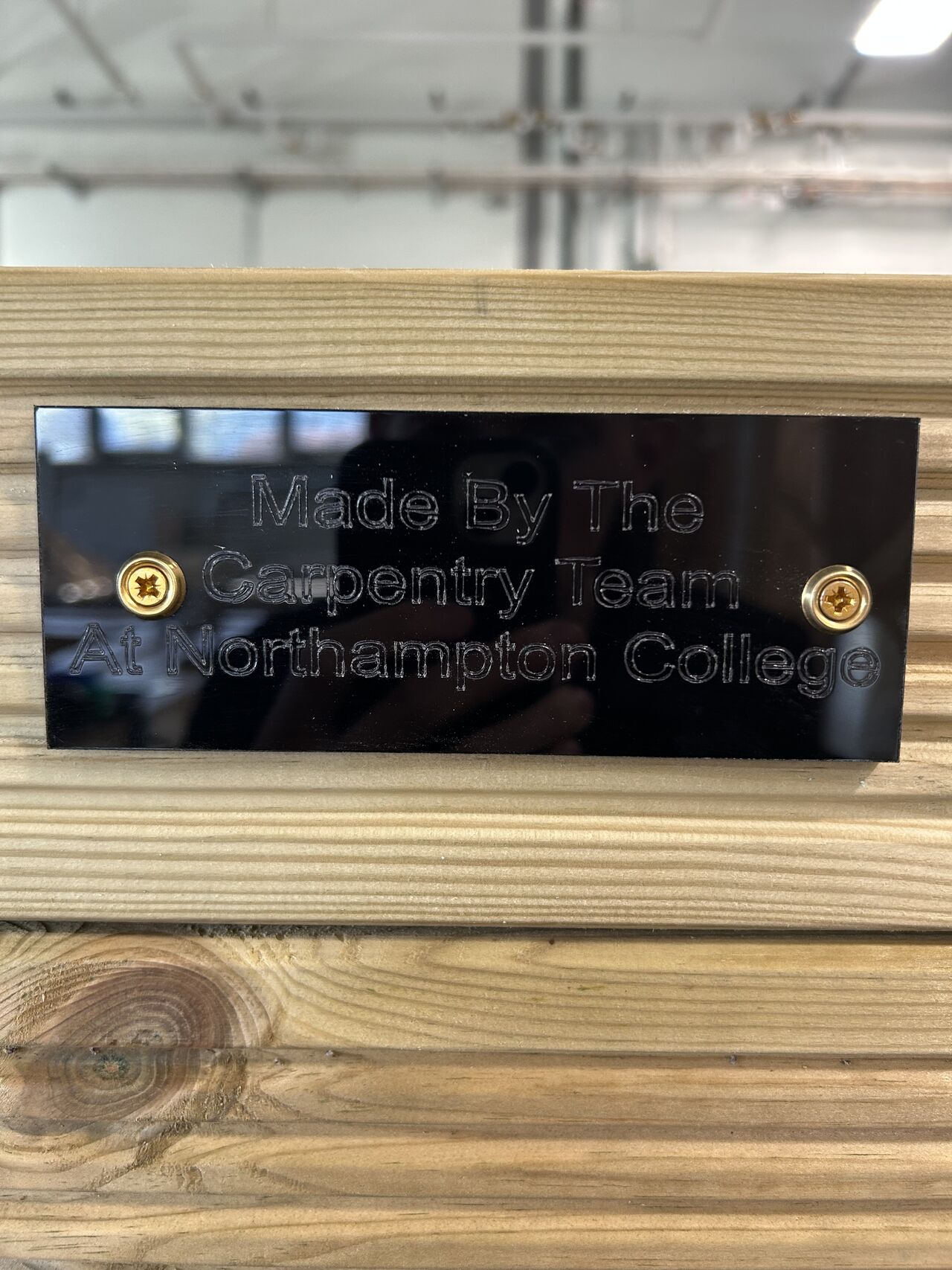 Plaque with Northampton College name affixed to planters