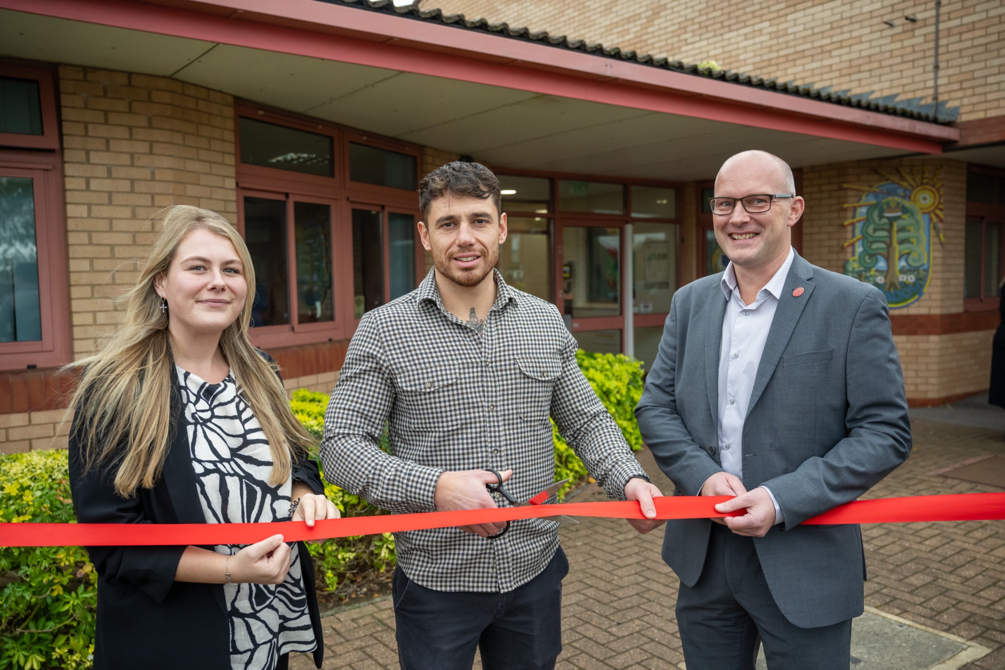 Head of School cutting ribbon with Barratt Homes representatives