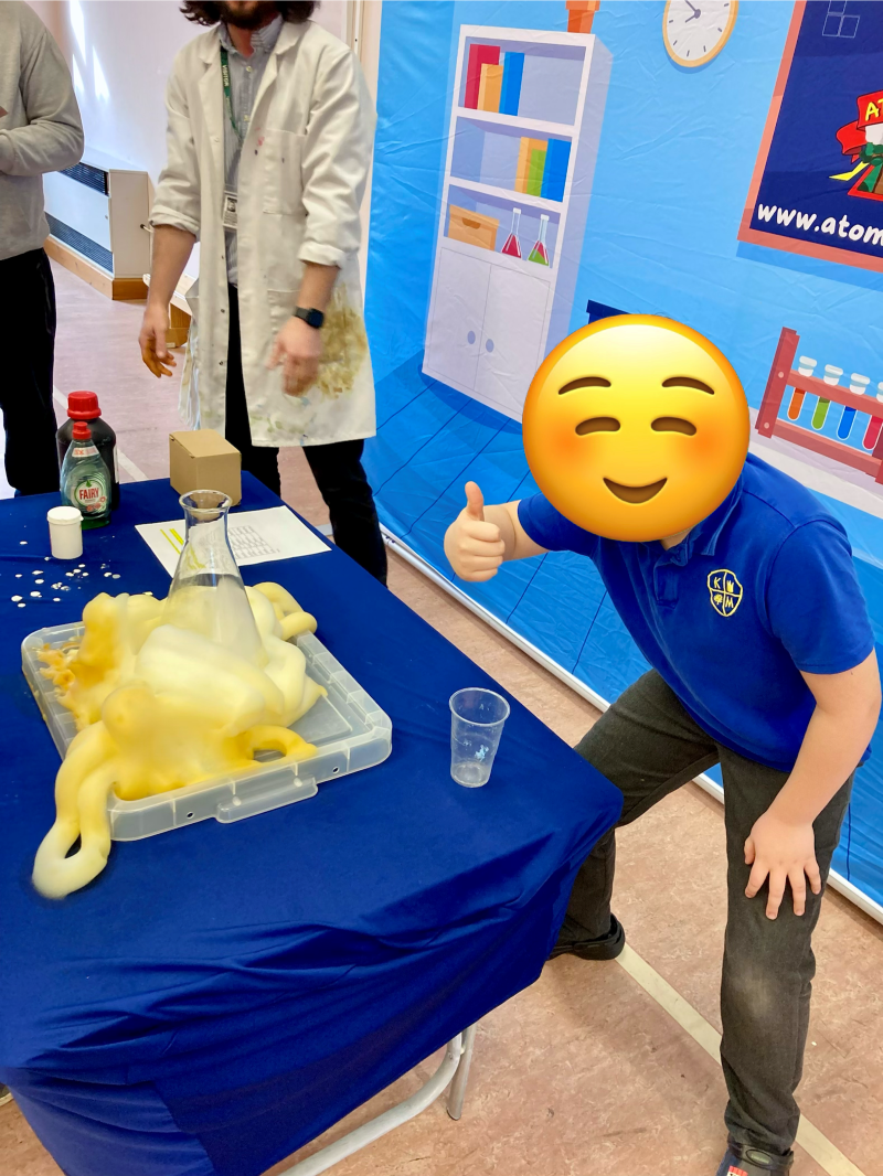 Boy giving thumbs up doing an experiment with atomic tom