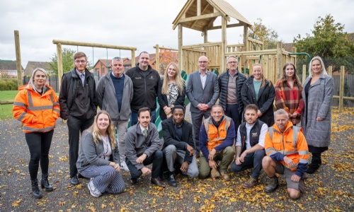 The Barratt Northampton team and their contractors standing in front of the new play area at Kings Meadow